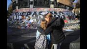 PARIS, FRANCE - NOVEMBER 15: People pause for thought at Place de la Republique as France observes three days of national mourning for the victims of the terror attacks on November 15, 2015 in Paris, France. As France observes three days of national mourning members of the public continue to pay tribute to the victims of Friday's deadly attacks. A special service for the families of the victims and survivors is to be held at Paris's Notre Dame Cathedral later on Sunday. (Photo by Christopher Furlong/Getty Images)